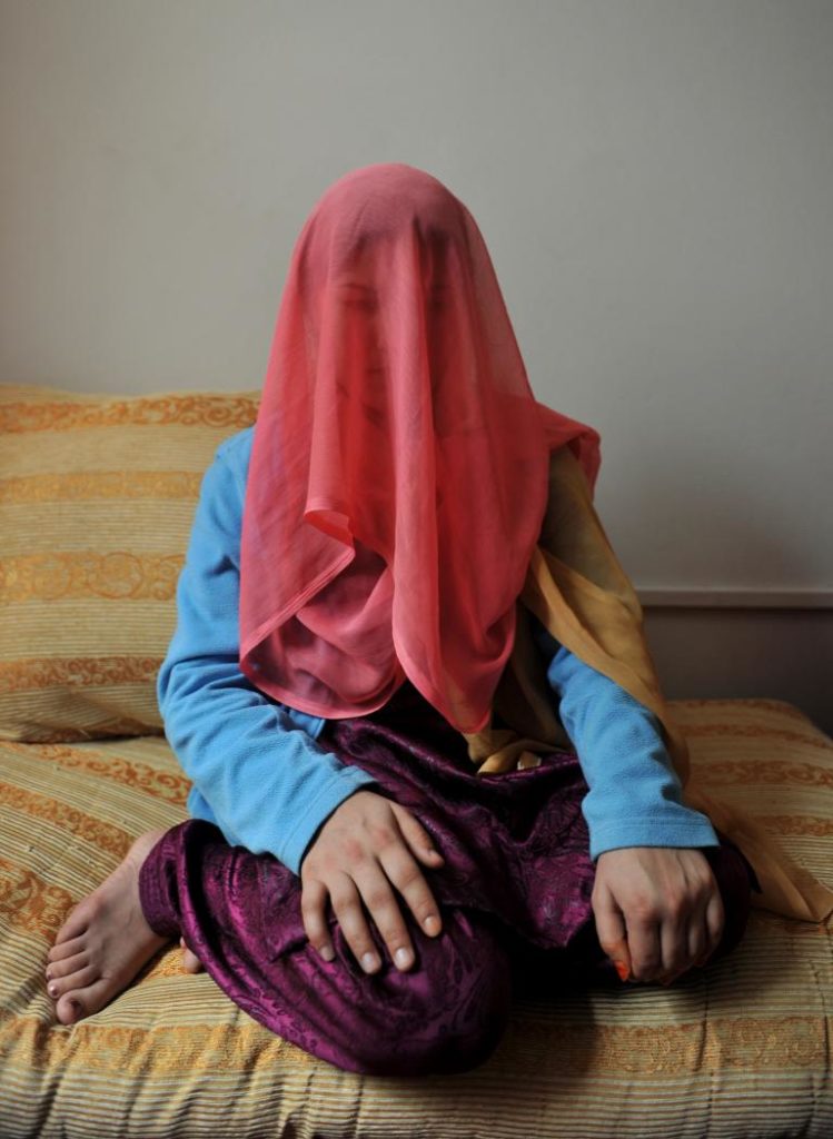 Parwin, 18, released from prison after two years in jail, poses for a portrait at a shelter run by women for Afghan Women in Kabul on October 12, 2011. Parwin was arrested by police in Jalalabad province and imprisoned after allegedly escaping from the home of her husband and 12 children. (Adek Berry/Getty Images)