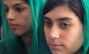 10th Graders (from left) Zareena and Zarafshan listen to Razia Jan describe her recent open heart surgery. "My heart was sad because I missed you," Jan tells them. (Photo by Beth Murphy)