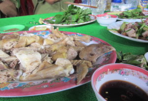 The next dish: chicken – head and feet included. (Photo by Joanne Silberner/GroundTruth)