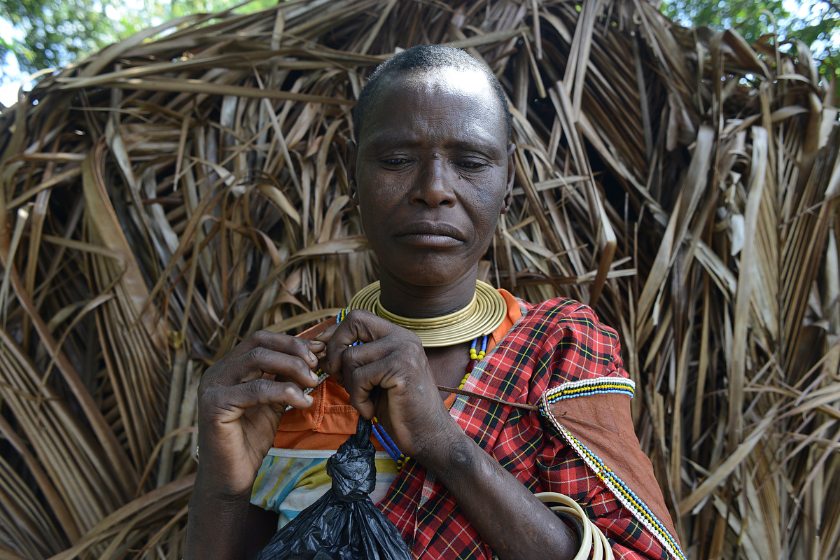 Udamugh, whose name means “waiting to heal,” plays with the yellow beads around her neck. She says she was forced to settle in Mkombani four years ago when park rangers from Mikumi National Park shot six of her cows, one by one, as she watched from inside her boma.