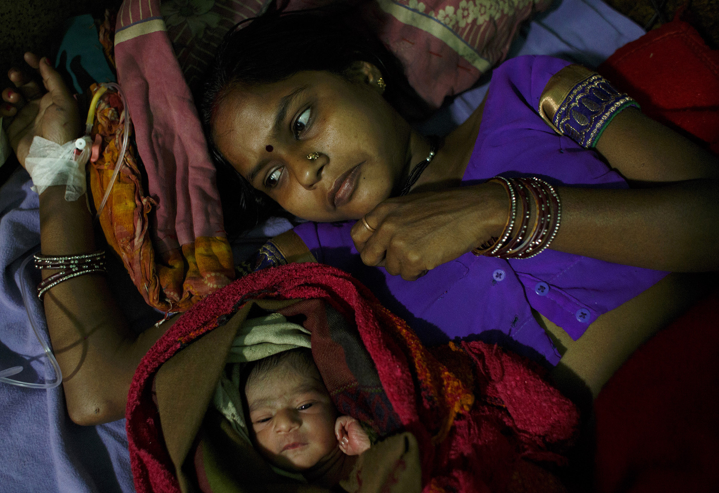 Munni Devi, 25, rests with her newborn, Sachin, at the Darbhanga Medical College Hospital in the northern state of Bihar. Devi has two children. India's fertility rate has declined from about 5.9 children per woman in the 1950s to about 2.4 today. But fertility remains higher in northern India, and Bihar has one of the highest rates in the country.