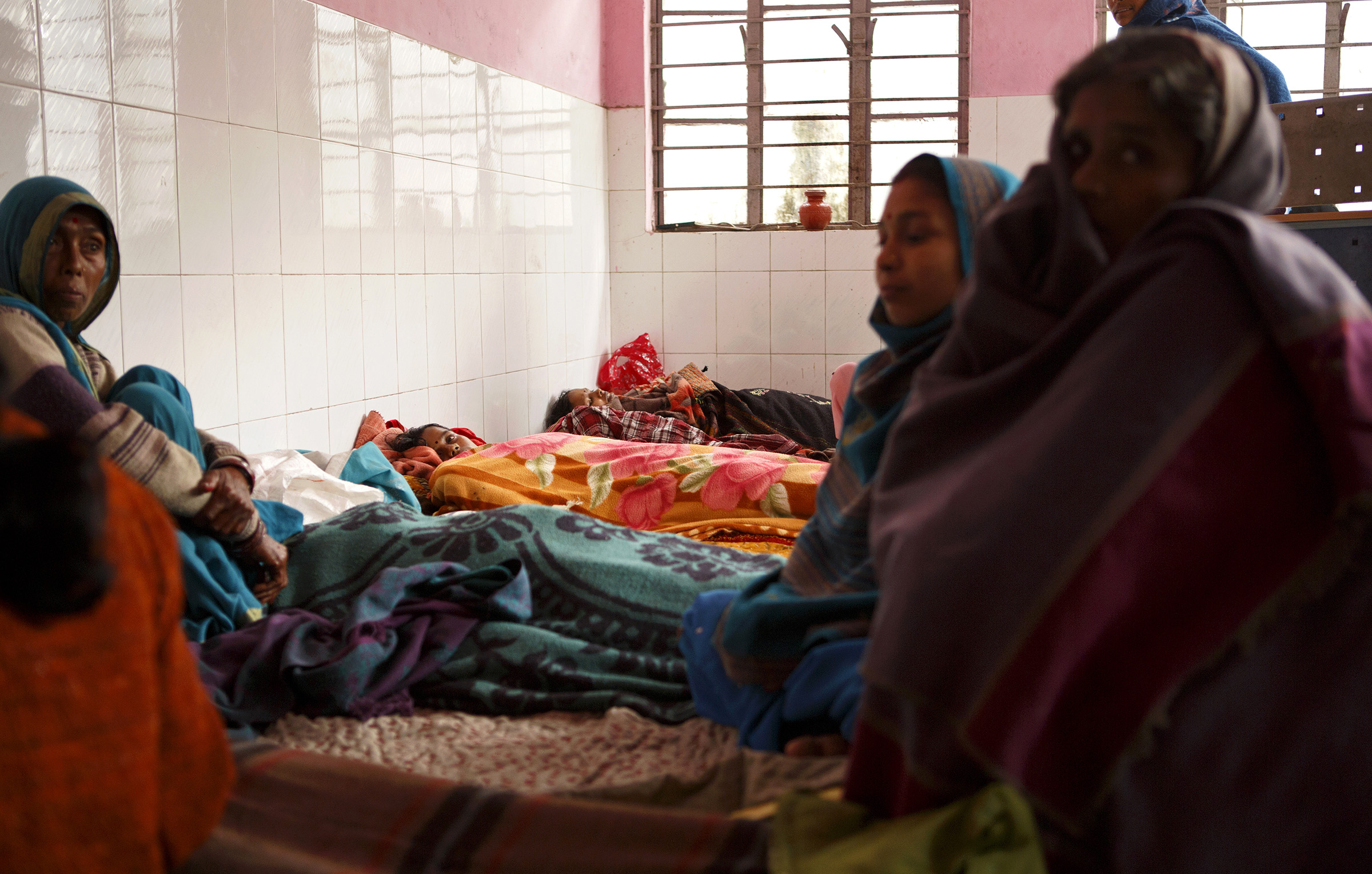 Surrounded by family members, women rest after having sterilization operations that day at the Cheria Bariarpur Primary Health Centre in the Begusarai District of Bihar in December. Sterilization is by far the most commonly used method of birth control in India. According to the most recent National Family Health Survey (2005-2006), 77 percent of sterilized women in India had never used any other method of birth control before sterilization. SARAH WEISER