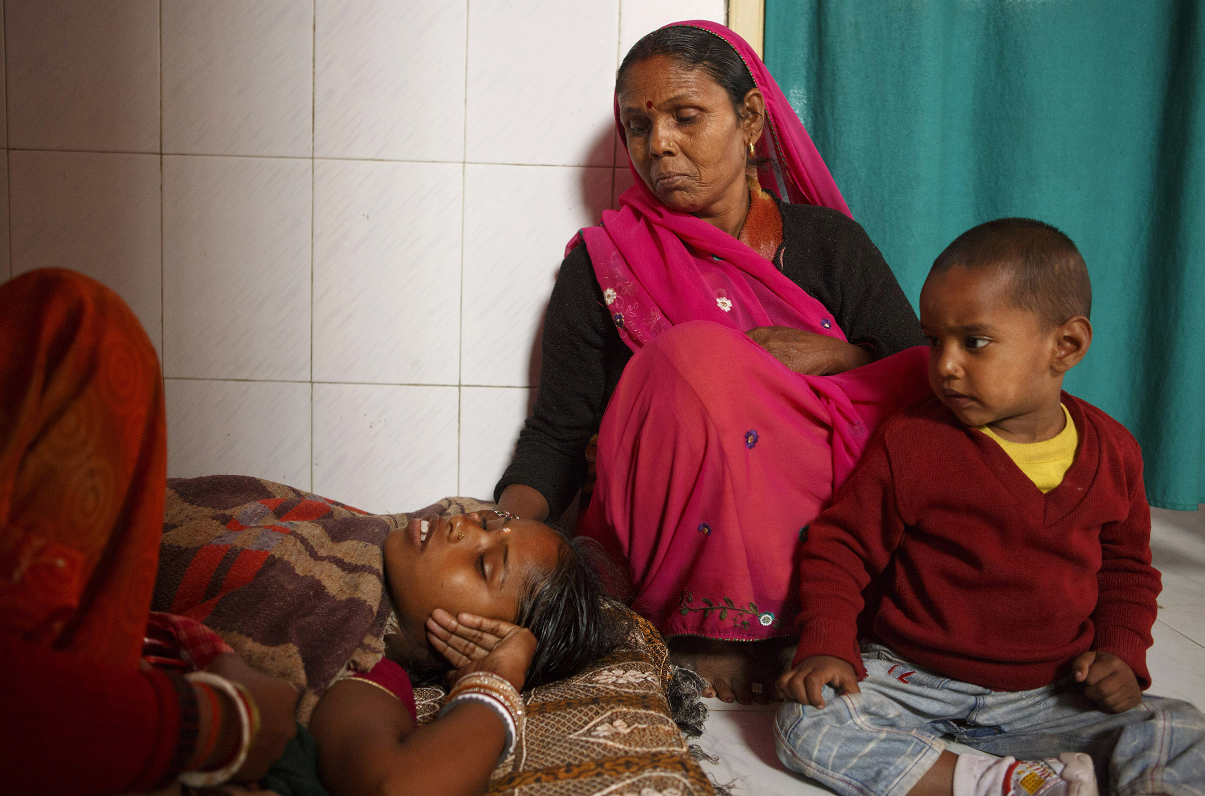 Nuta Devi, center, with her daughter, Manju, left, who rests after her sterilization surgery at the Cheria Bariarpur Primary Health Centre in the Begusarai District of Bihar. A sterilization clinic was held that day for women wishing to be sterilized. Many health care workers point out that sterilization is a one-time procedure that requires little follow-up care, and for rural women without regular access to health services, and less autonomy in their decision making, it can often be the best tool they have to control their own fertility. SARAH WEISER