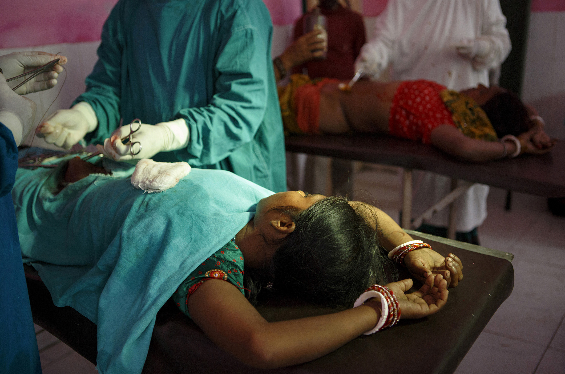 Women undergo sterilization operations at the Cheria Bariarpur Primary Health Centre in the Begusarai District of Bihar. A few dozen women were sterilized in one day. Although India officially abandoned sterilization targets years ago, unofficial targets remain in place, according to people working on the ground. One Primary Health Centre doctor says the targets in themselves are not necessarily the problem, arguing instead that itÕs the lack of a good healthcare infrastructure in some places that makes it difficult to safely meet those targets. SARAH WEISER