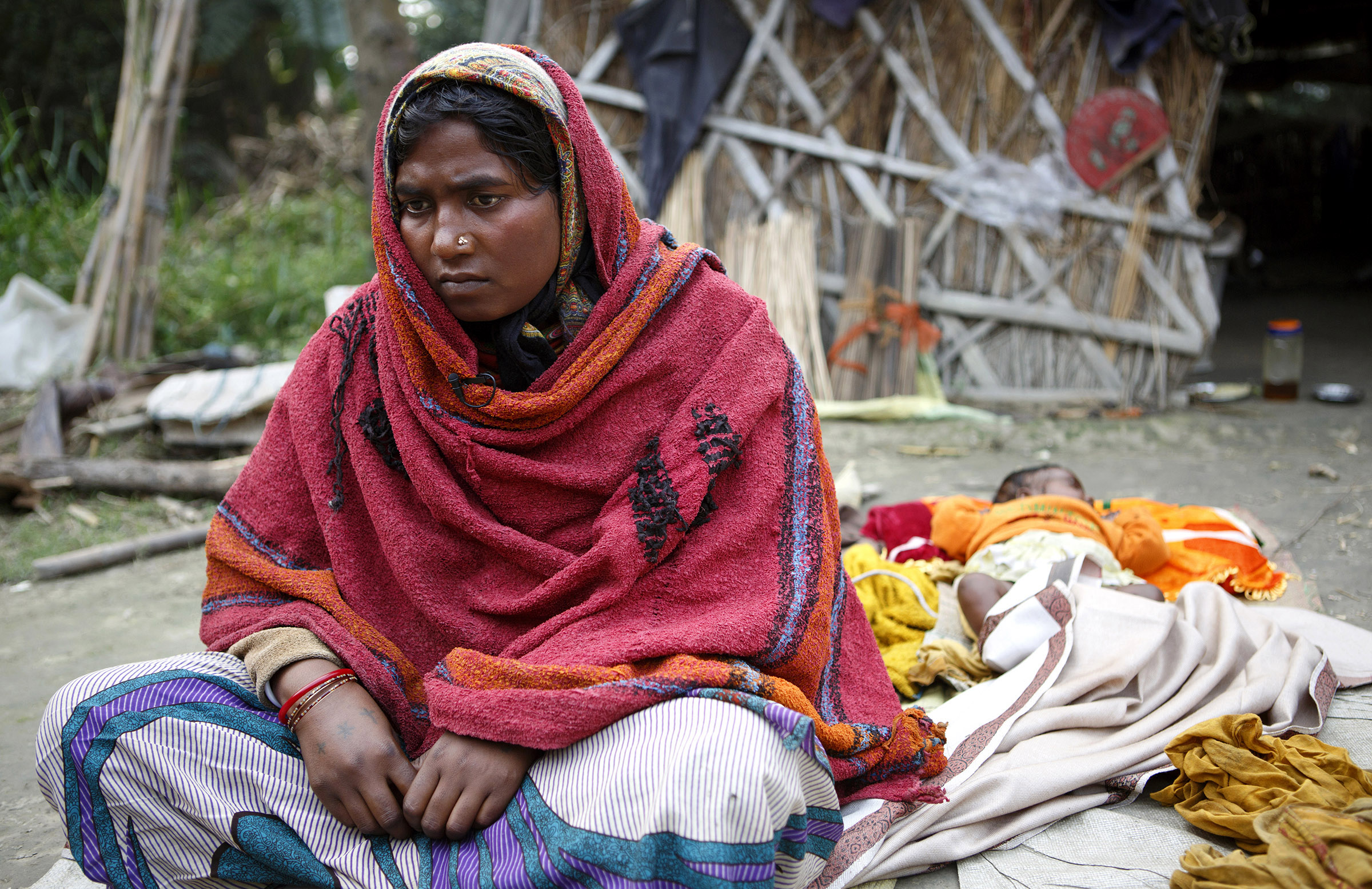 A few days after her sterilization operation, Sonia Devi, 35, recuperates at home with her newborn daughter, Lovely, her fourth child, in the Begusarai District in Bihar. After she gave birth, Sonia says an asha, an accredited social health activist, told her about the option of using sterilization to limit her family size. Sonia didn't appear to be aware of other methods of birth control. SARAH WEISER