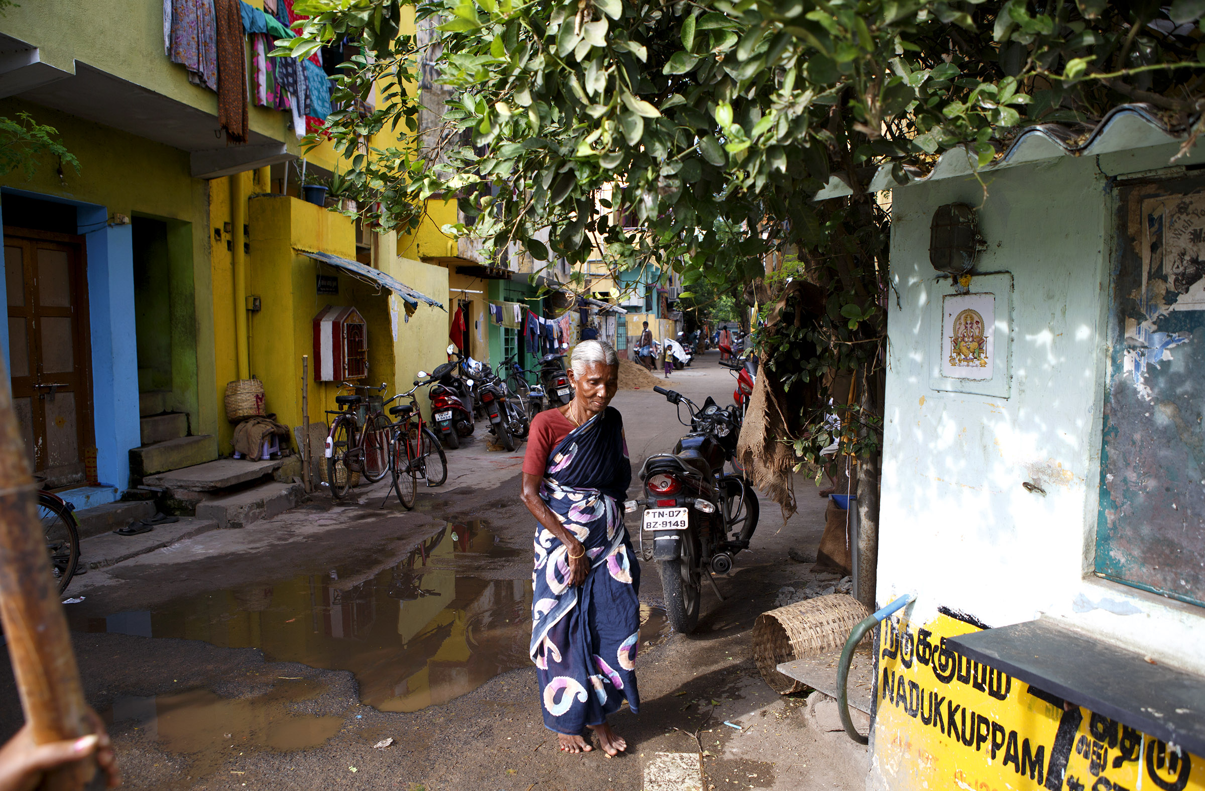 A woman walks through a neighborhood in Chennai, Tamil Nadu. The state has much lower fertility rates than elsewhere in India. There has been an effective family planning program for years here, but experts say that big improvements in the health and education system have been just as important. Maternal and infant health have greatly improved, literacy rates are higher, and infrastructure developments like roads and electricity are more widespread.