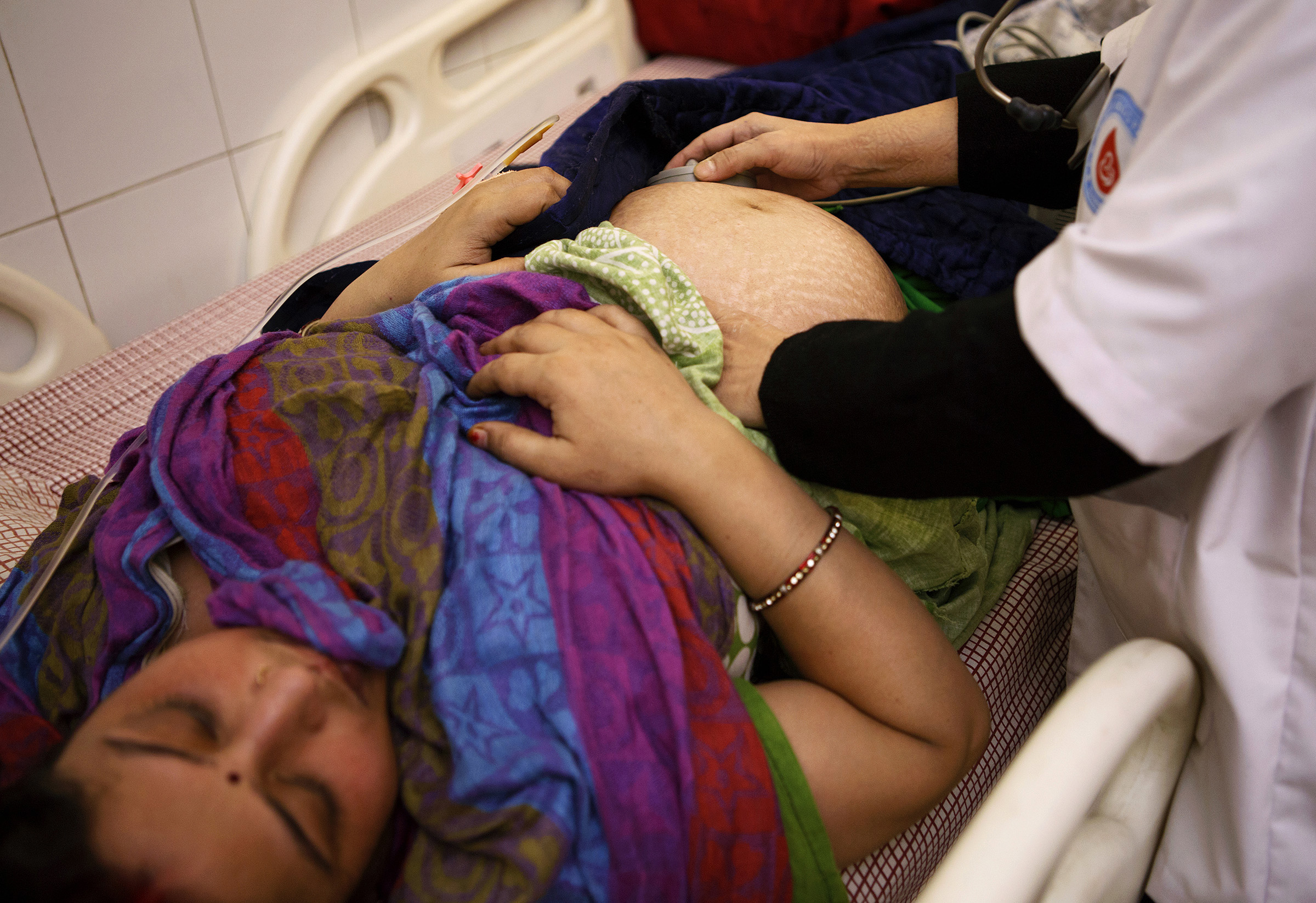 In recent years in Bihar, maternal care has improved too. Here, Rashmi Devi, 31, pregnant with her third child, is examined by Dr. Gunjan Trivedi at the I. B. Smriti Arogya Sadan Hospital in the city of Darbhanga, Bihar. SARAH WEISER