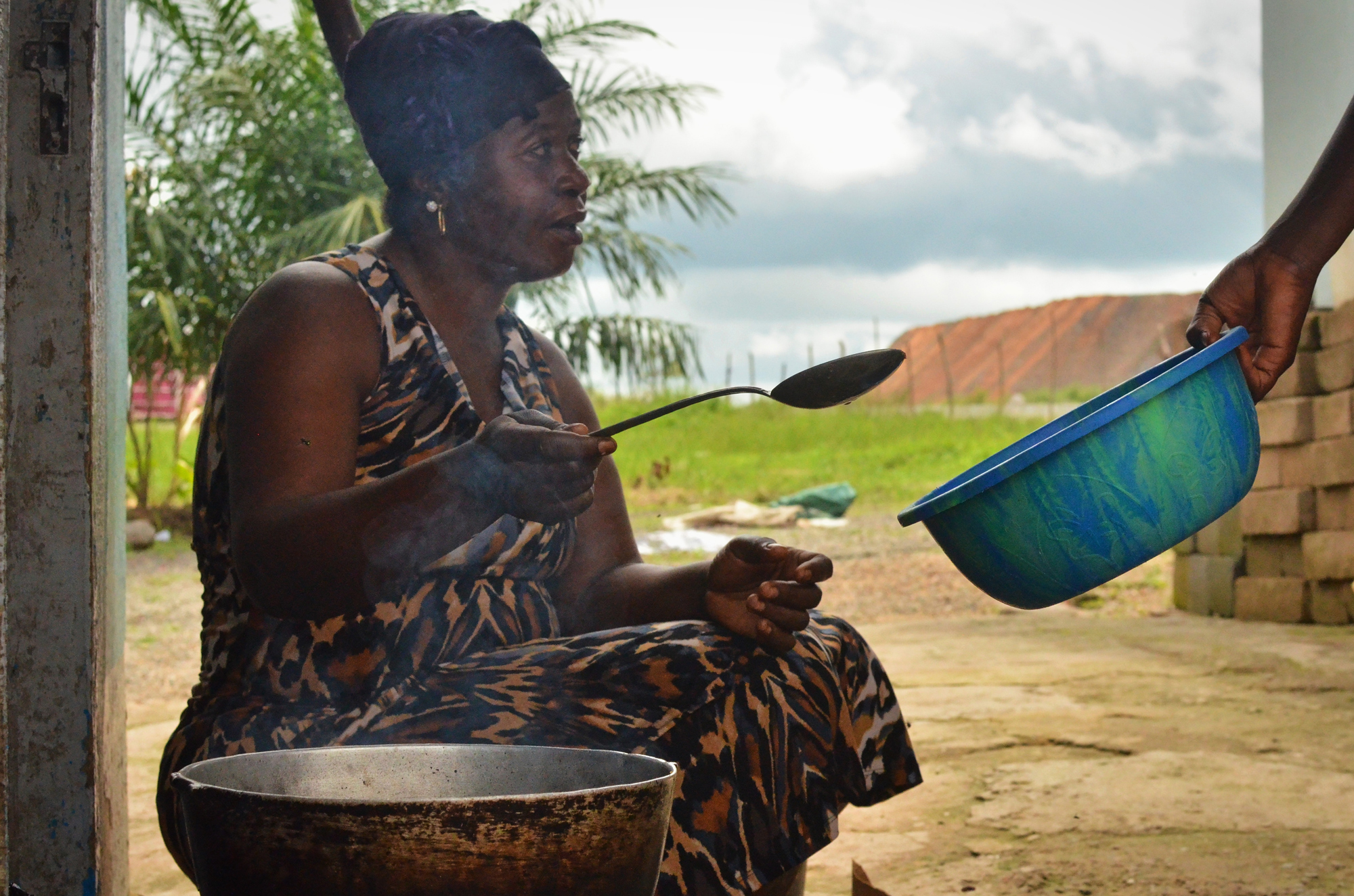 Jariatu Kamara, the wife of a local chief, was one of several people moved to the resettlement site in 2010 after the mine's safety zone was expanded to 500 meters. She says that the new house is a welcome improvement to their old property.