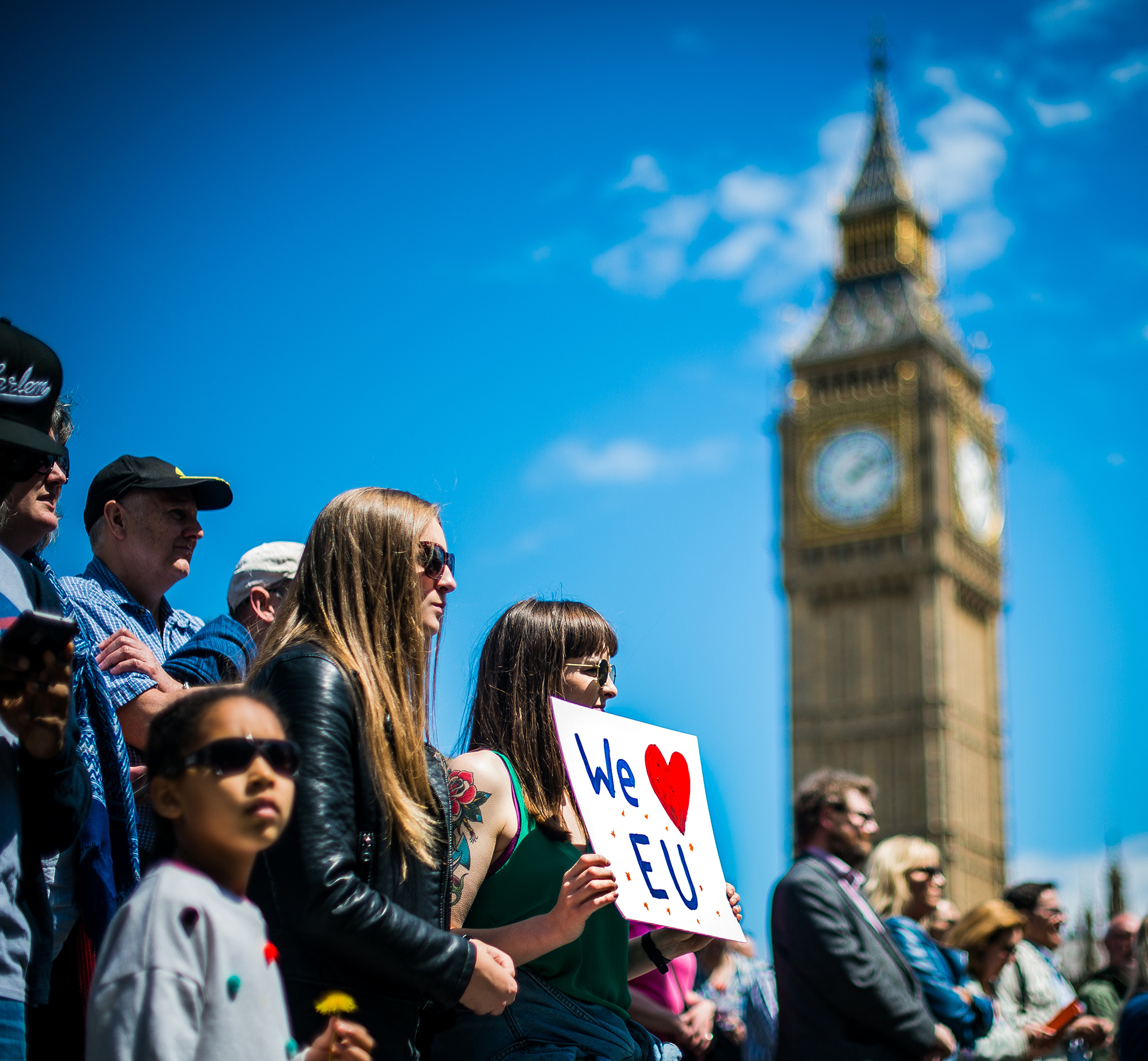 A young woman holds up a sign in favor of the European Union at the 'March for Europe' protest on July 2, London's Big Ben visible in the sky above. (Photo by Garon S/Flickr User)