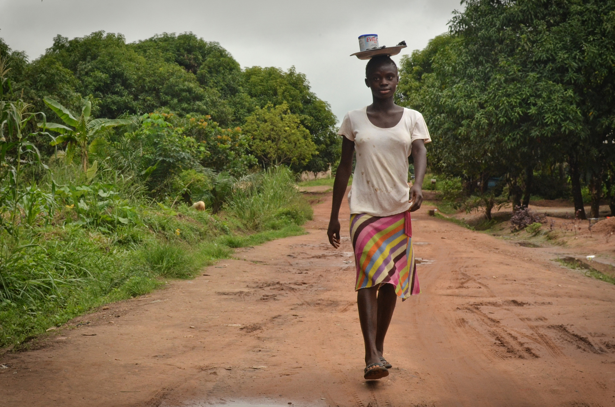 Sia Momoh's father, an artisanal miner named Aiah Momoh, was shot and killed by police in 2007 while protesting mining activity. Sia, now 15 years old, lives with her aunts and grandmother and spends her days selling produce and butterscotch around town.