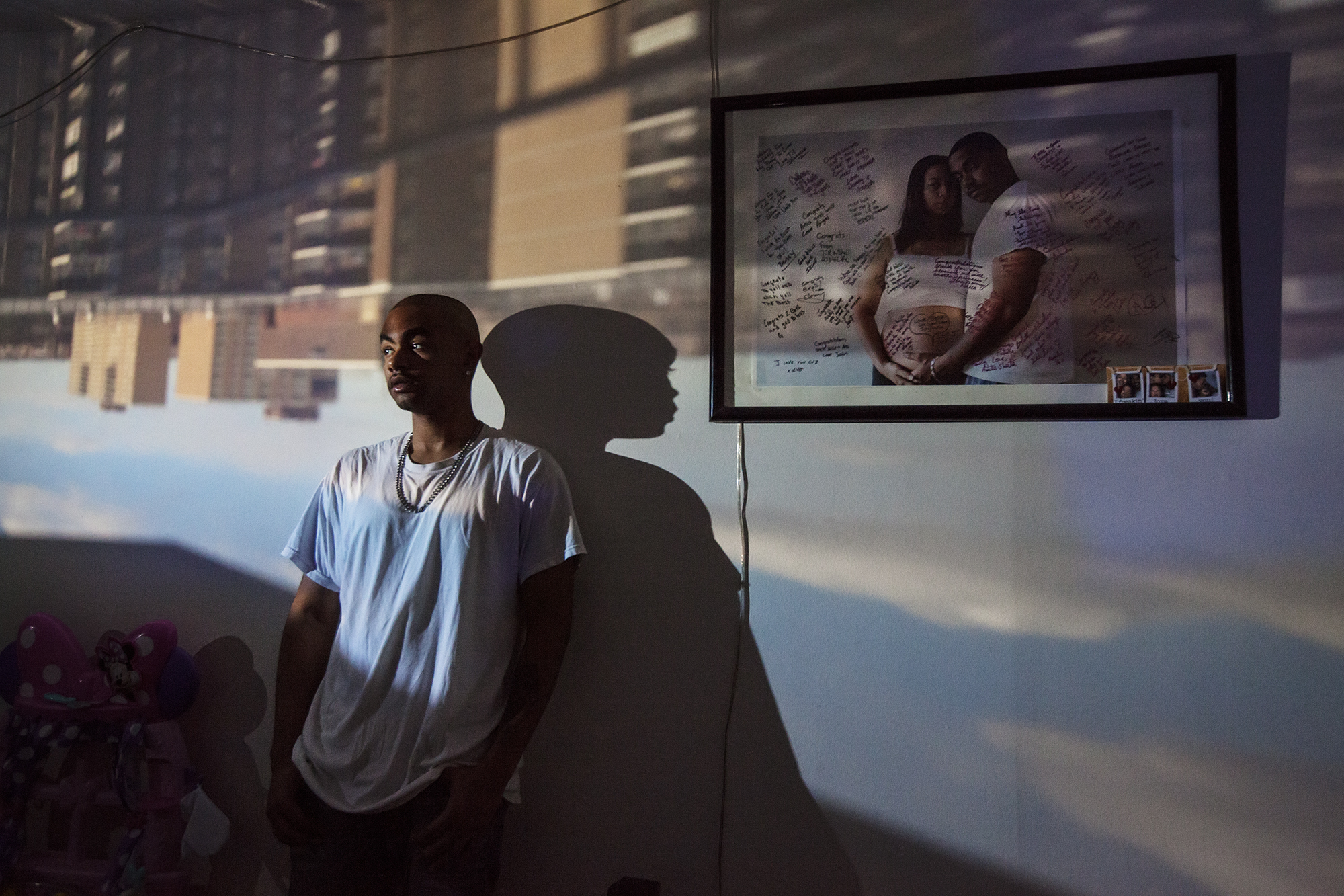 Willie Johnson poses for a portrait in East New York, NY on Feb. 13, 2016. Raising East New York (RENY) is a portraiture project about Black fathers where the photographer Phyllis B. Dooney uses a technique called Camera Obscura to project the outside streets of East New York into the subjects apartment in real time.