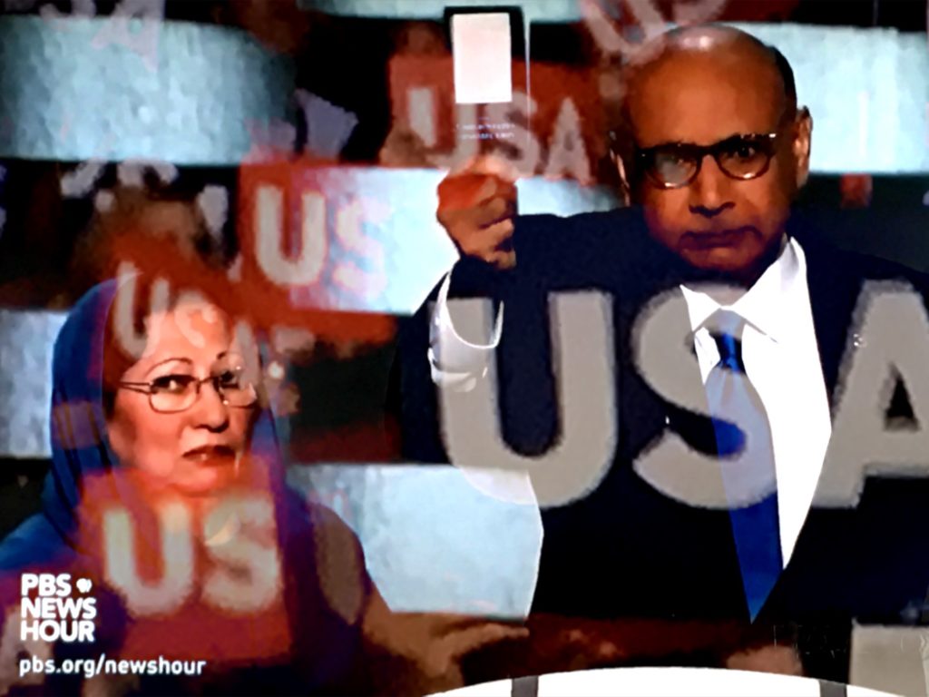 Parents of fallen U.S. Army Captain Humayun Khan, Ghazala and Khizr Khan, address the DNC, displaying a copy of his pocket U.S. Constitution. (Composite image by Biz Herman/GroundTruth)