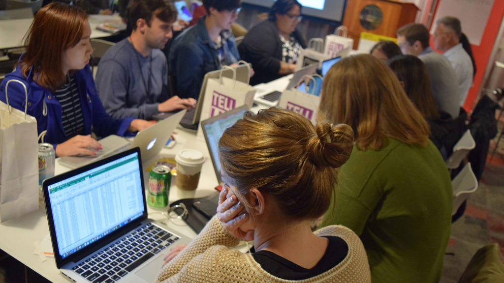 Graduate students from Northeastern University analyzing crime data from the City of Boston as they try to piece together a possible story. (Frank Dutan/GroundTruth)