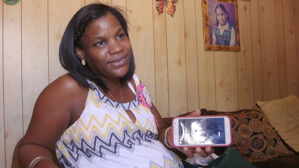 Dahiana Santana shows a sonogram of the baby she's carrying. She worries she might have contracted Zika during her pregnancy, but she never received her test results. (GroundTruth Films)