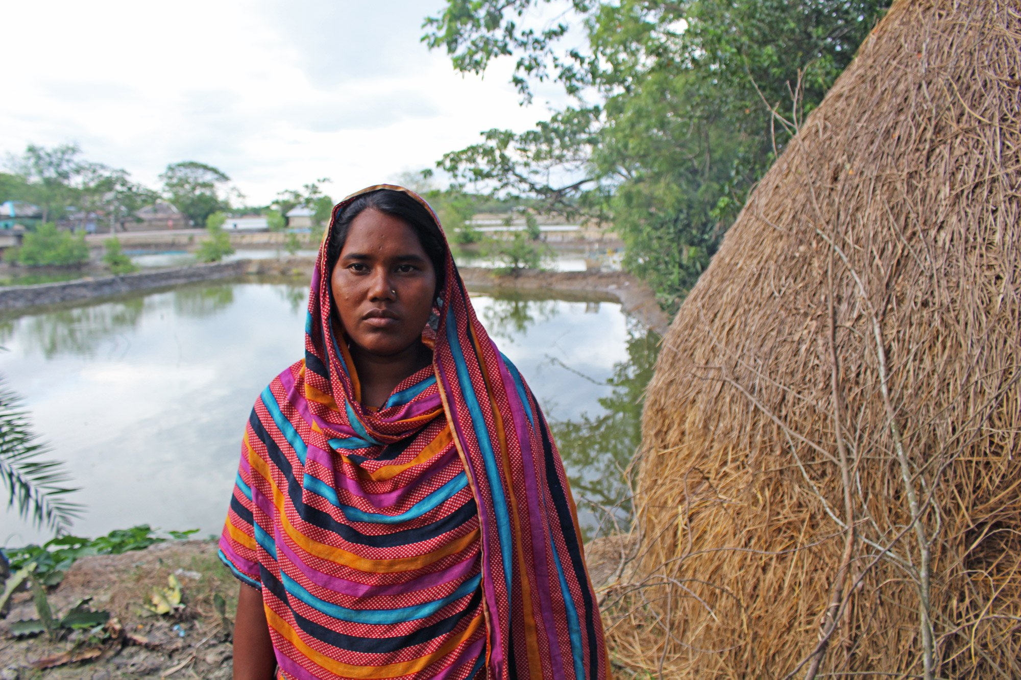  “The agriculture is not good here, the saline water comes from below in the soil. Some time after planting paddy, it becomes red and dies out,” Romesa Khatun 27, said. (Photo by Neha Thirani Bagri/GroundTruth)