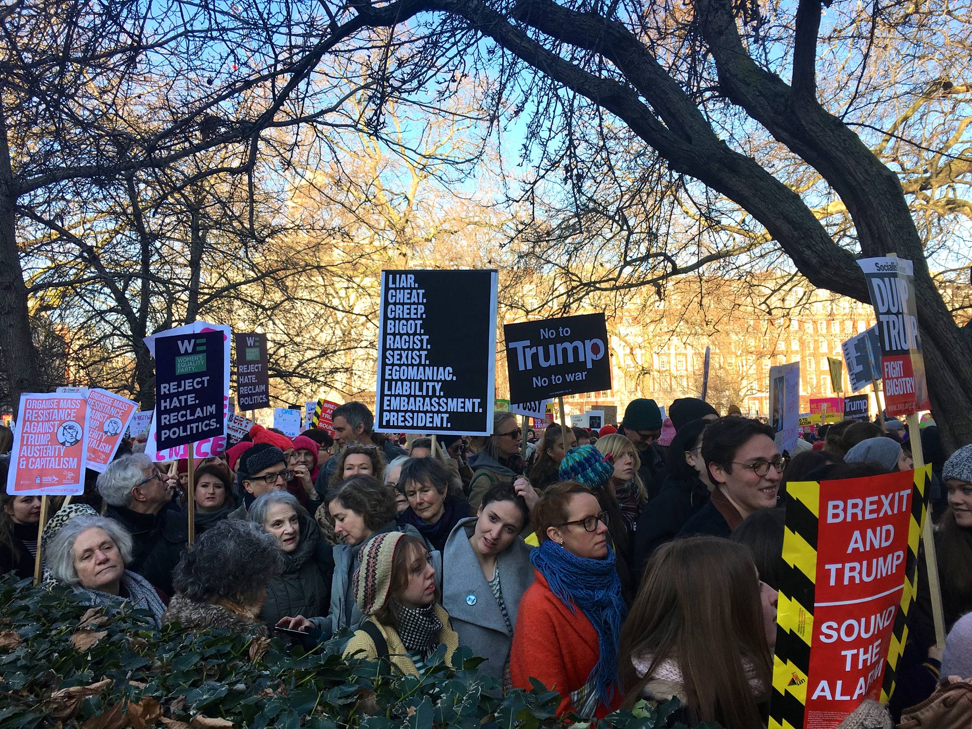 Protestors hold up signs with a list of complaints against U.S. President Trump in London on Jan. 21, 2017. (Photo by Devi Lockwood/GroundTruth)