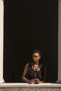 Catholic University of Rio journalism student Gabrielle Roza in a pensive moment at the Black Power Girls Annual Fair in Rio's port zone. Roza is part of the collective that launched her university's first black student newspaper. Both are called Black Cloud. (Photo by Leonardo Coelho/GroundTruth)