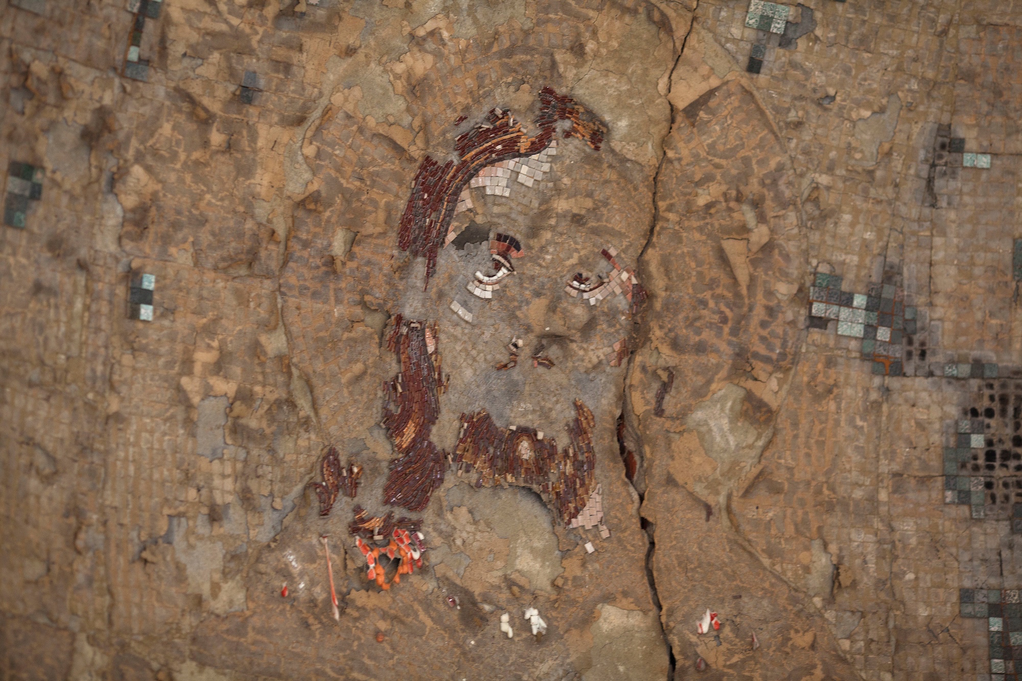 A damaged mosaic of Jesus inside the St. Mousa church in Minya, Egypt. In 2013, the temple was one of the dozens of churches, businesses and homes that were burned during a surge of violence against Egypt's Christian minority.(Photo by Heidi Levine/Sipa Press).