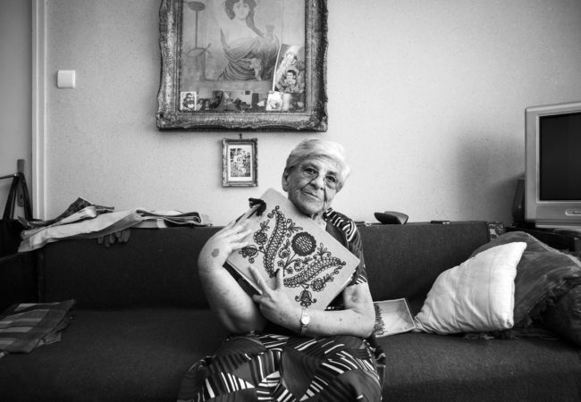 Auschwitz survivor, Iudit Varadi, 87, poses for a portrait with her family photo album at her home in Oradea, Romania on August 18, 2013. “My brother and mother died in the camps. Altogether, I lost around eighty members of my extended family in the Holocaust, so when I returned home I was alone. I had to start my life all over.” Mrs. Varadi passed away shortly after her portrait. (Photo by Daniel Owen/GroundTruth)