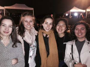 Pauline Guérin (far left), Julie Boyer (second from left), Camill Hegues (far right) are pictured on election night in Paris. (Photo by Emily Schultheis/GroundTruth)