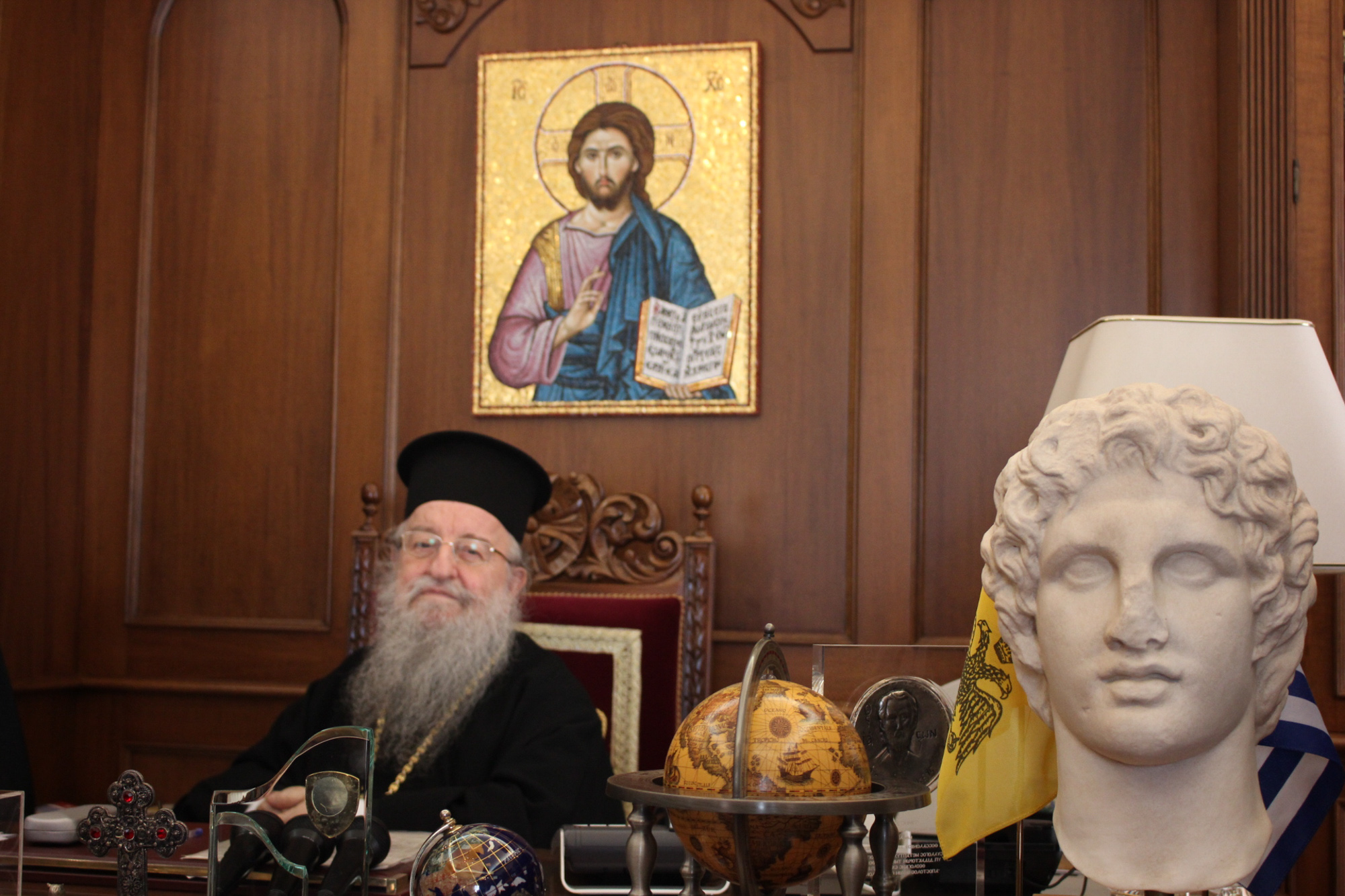 Bishop Anthimos of Thessaloniki sits behind his desk in the city’s cathedral. The Greek Orthodox Church has come under fire from NGOs and volunteers for not doing more for refugees in Greece. (Photo by Alexandra Meeks/GroundTruth)