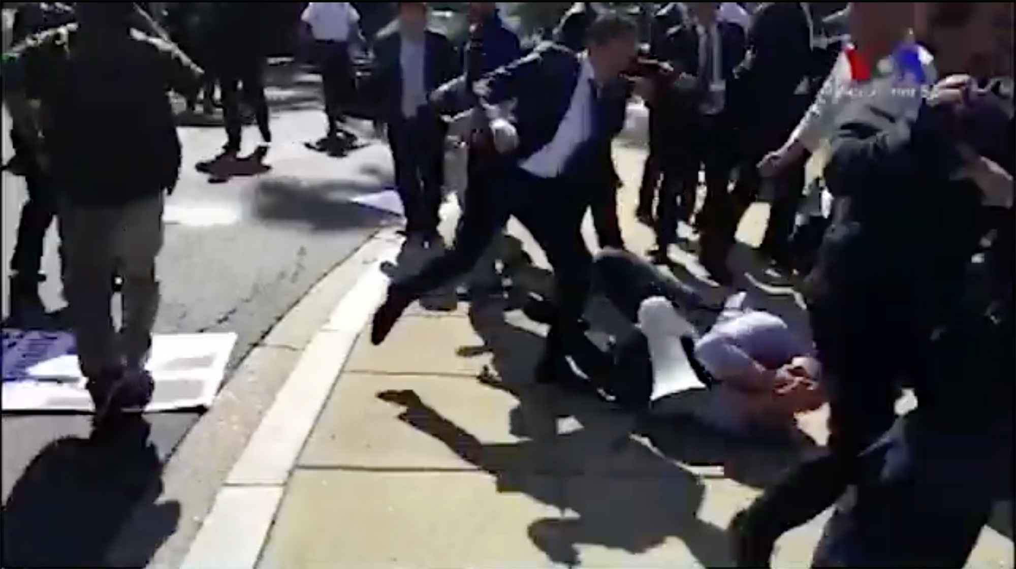 In this screenshot from a video posted on Twitter by VOA Turkish, a man can  be seen kicking a protester on the ground. | The GroundTruth Project