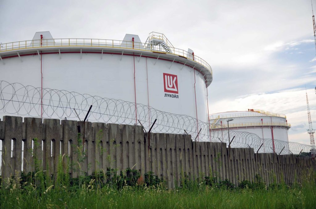 Fences topped by barbed wire surround oil storage tanks at the Lukoil port facility in Burgas. (David Jordan/Medill/GroundTruth)