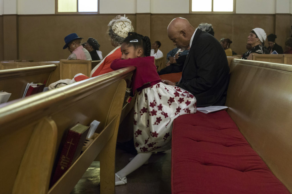 Acacia Brownlee, 5, sits on the edge of a pew during the service at the Third Baptist Church in the Fillmore district of San Francisco, California, on Sunday, November 5, 2017. (Photo by Brittany Greeson)