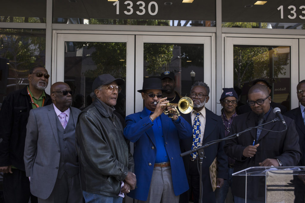 Dr. David Hardiman plays the trumpet during a rally outside the Fillmore Heritage Center. (Photo by Brittany Greeson)