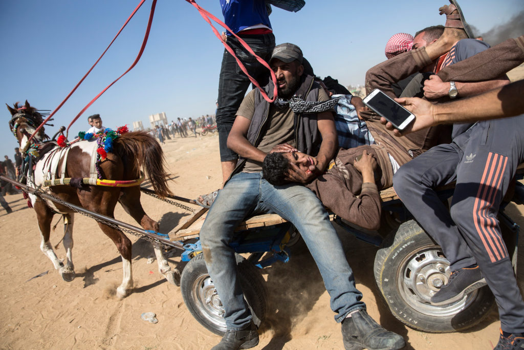 An injured Palestinian shot by Israeli forces is evacuated by wagon and horse. (Heidi Levine/GroundTruth)