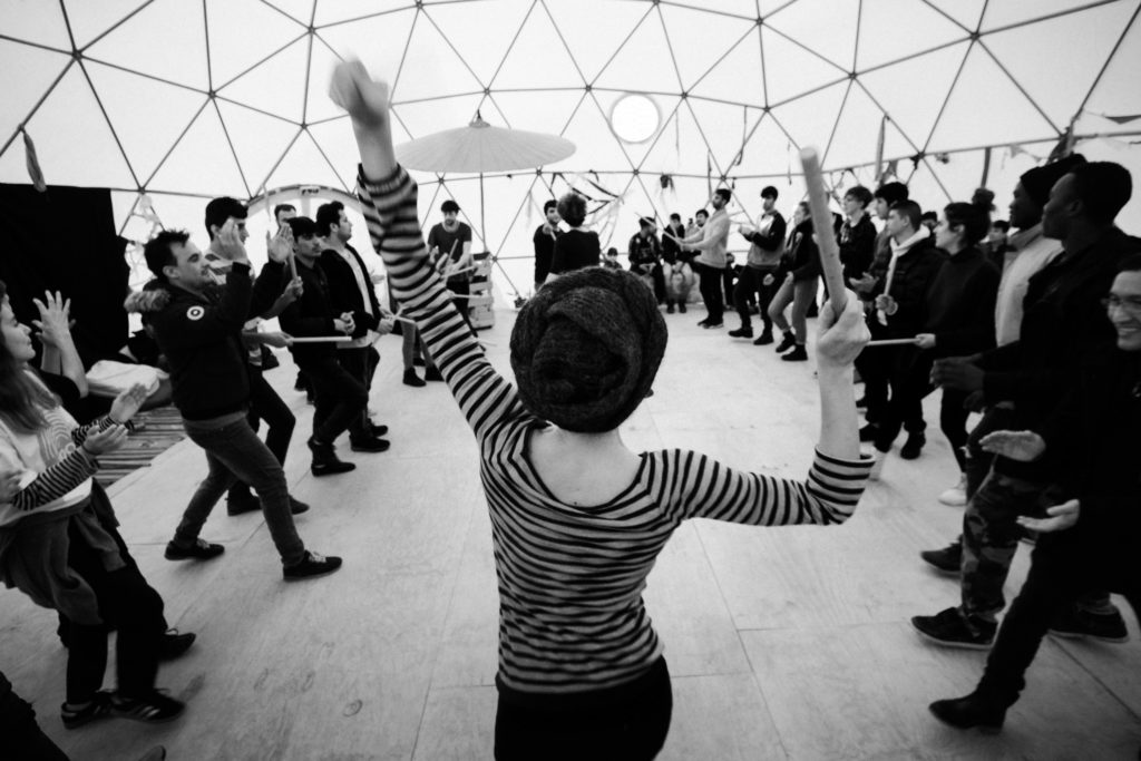 Visiting artists Silvia Ribero Rottensteiner (center) and Angela “Angie” Rottensteiner (not pictured) of the Italy-based Biloura Intercultural Theatre Collective lead a February 16 workshop involving group dance and beat-making. After several weeks spent with Good Chance, the two artists recalled: “We have seen young men used to acting hard for survival playing with paper-puppets delicately as 6-year-old children. We have seen sad man laughing. We have seen big man crying at the goodbye moment. We have seen artists sweating until death to lead the group and never giving up, and all the Good Chance people working tirelessly to arrange and solve and organize and listen and answer and translate. It has been so precious... We believe the power of Theatre is huge, subtle, astonishing, that it left a mark in all of us.” (Photo by Annabelle Marcovici/GroundTruth)