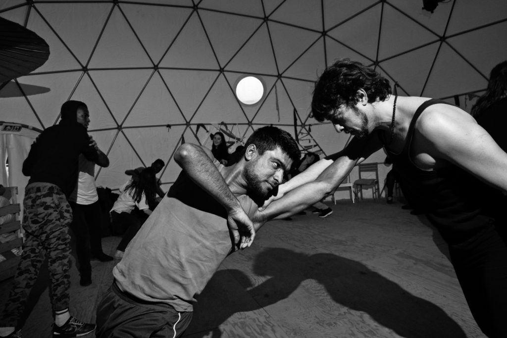 Visiting artist Pierre-Yves Massip (right) — one half of the French theater company Compagnie Mangano-Massip — co-leads a February 15 workshop on physical theater. (Photo by Annabelle Marcovici/GroundTruth)