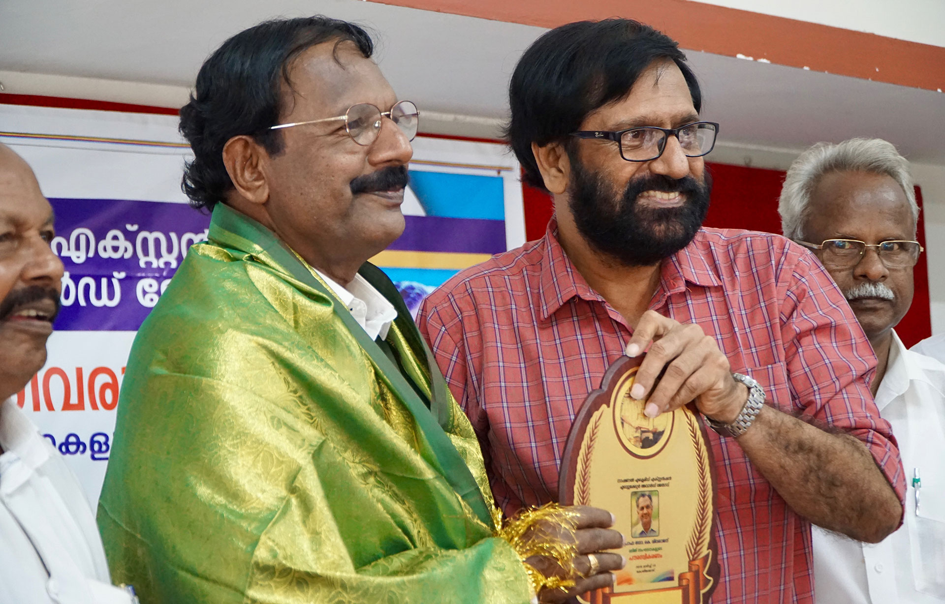 K.P. Ramanunni presents an award to K. Sivaraj, a Dalit education reformer. (Photo by Krishna Narayanamurti) 